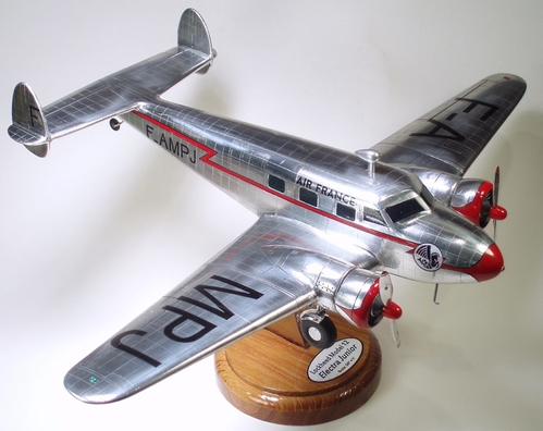 Lockheed 12 Electra Jr Model
3/8" = 1' solid scale model.  Constructed of aspen, wood grain sealed with polyester resin.  Foil covered, enamel trim.  Windows simulated with polyester resin.
