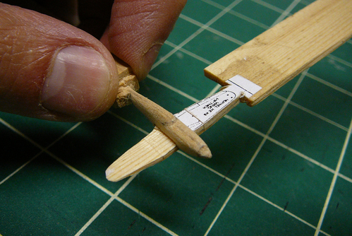 1. Teeny-Tiny Heinkel "He 113" (He 100)
Marsh posted some instructions for how to carve tiny airplanes.  I decided to try this with a 1/288 scale Heinkel He 113, which was really the He 100D-1.  You can see that the wing and fuselage are still attached to the stock, so that I have something to hold onto while I carve them.

I carved this at a picnic table in a park.  The whole tool kit fits into a small pencil case, with the exception of a 12 mm chisel.
Keywords: solid model airplane heinkel he-113