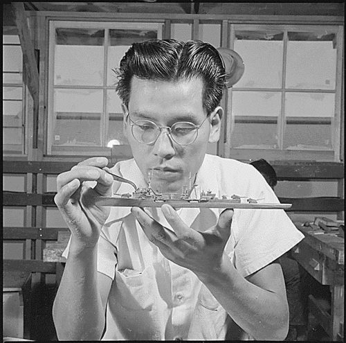 Working on an ID model
Photograph taken by US Department of the Interior, War Relocation Authority at Gila River Relocation Center, Rivers, Arizona during World War II.

Gila River Relocation Center, Rivers, Arizona. Tadashi Imai, former Los Angeles fruit stand worker, is shown putting the finishing touches on a model ship. These models are used by the Navy in training schools. Tadashi, prior to evacuation, had made model ships as a hobby. 
Keywords: ID model ship spotter WW II