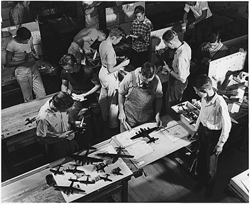 High Schoolers making ID model airplanes
196477
Title: 	Since Pearl Harbor, students are constructing scale model planes to Navy specifications, to be used in training military and civilian personnel to be familiar with all types of planes., ca. 10/1942

FDR Library Photo
Keywords: ID Model airplane