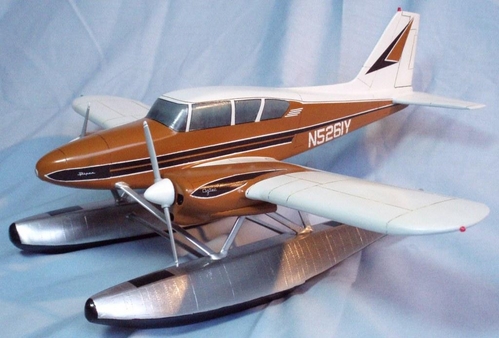 PiperAztecFloatplane_LeftSide
1/32 Piper Aztec float plane.  Model constructed from pine from 3-view drawing found on internet.  Floats are from basswood.
Model was painted using Testors and Kustom Kolor (flat white) enamels.  This was the first time I used Valspar Kustom Kolor paint and it gave excellent results; that paint line was briefly available at the local WalMart before they stopped carrying model supplies.
Floats are covered with aluminum foil using MicroScale foil adhesive following the technique described in an article from the July 2002 issue of FineScale Modeler magazine.  The key is to use the cheapest foil obtainable: cheap foil means it is thinner which is best for this purpose.  The anti skid surfaces are made from flat black painted tissue paper applied with a glue stick.  Panel lines and control surface demarcations were made using a wood burner before the model was painted.
