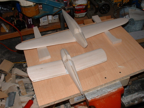 Fairey (Tipsy) Junior
The wings have been joined to the fuselage via brass rods with the correct dihedral angle,the cockpit aperture was pre cut before the fuselage sides were joined together with a ply membrane in the middle,this really aids sanding to fial shape as you have a permanent centreline to work to.
In the background the British Klemm Eagle receives the same treatment with the wings jigged up.
Keywords: FAIREY (TIPSY) JUNIOR MONOPLANE,Solid models,carving models in wood,Solid model memories,old time model building,nostalgic model building