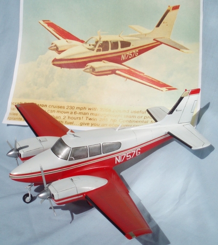 RedBaron_Ad
Beechcraft D55 Baron.
Scale:  3/8" = 1' (1/32 Size)
Paint scheme on model is based on a photograph used in Beech advertising.  Photo shown in background appeared in a 1968 issue of "Flying" magazine found in back issue stack at library.  For use as reference, the magazine page was photographed on site at the library using a digital camera.

