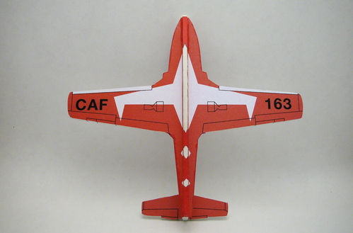 1/72 scale Canadair CT-114 Tutor (bottom)
Here is a profile-scale model I made of a Canadair CT-114 Tutor painted as a member of the CAF Snowbirds precision aerobatic team.  I chose this subject in tribute to all the wonderful Canadian model builders I keep in touch with.

I cut the parts from thin plywood, then glued them together and filled the grain.  After coats of primer and then white paint, I was left with a blank canvas of an airplane.  This was back in January 2008.

I finally decided that rather than try to paint all the color stripes and then glue on small pieces of paper with the roundels, flags, and logos ("paper decals"), I'd cheat a bit and use really large paper decals.  

I printed the covering in 12 sections and carefully pasted them on.  Then I mixed paint to match the colors as best I could and painted the edges of the plywood to match.  This gives a "wrap-around" appearance and really helps make the model look realistic.  You can see here that the white diamonds on the bottom line up if you look from the right angle.

Total time was 6 hours, including computer time drawing the decals.
Keywords: canadair CT-114 tutor profile scale model airplane